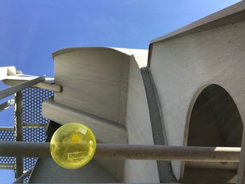 Low angle view of metallic structure against blue sky