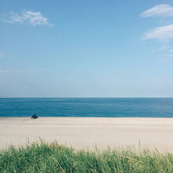 Scenic view of sea against blue sky