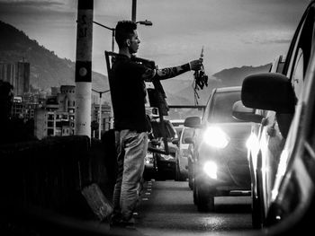 Man standing in city against sky