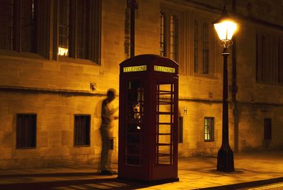 Full length of man at telephone booth