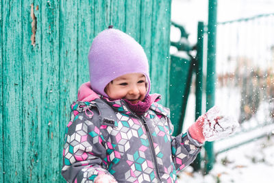 Happy child outdoors in winter on the background of nature. child portrait looking to the side