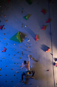 Anonymous athlete climbing the wall
