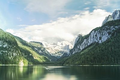 Scenic view of lake and mountains against sky