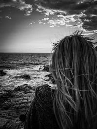 Portrait of woman looking at sea against sky