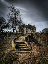 Staircase of old building against sky