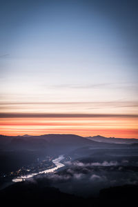 Scenic view of silhouette mountains against sky at sunset