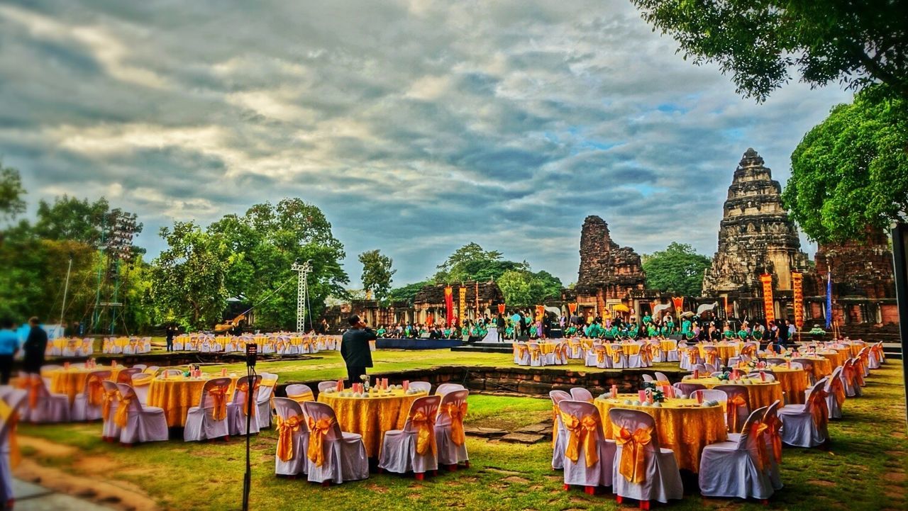 sky, cloud - sky, tree, built structure, architecture, building exterior, cloudy, temple - building, place of worship, religion, spirituality, cloud, wood - material, outdoors, roof, day, tradition, grass, large group of objects