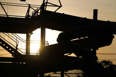 Low angle view of silhouette built structure against sky