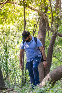 Full length of man standing by tree in forest