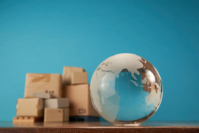 Close-up of crystal ball against blue sky