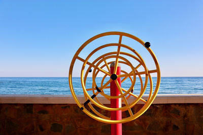 Fitness  wheel on beach against clear sky