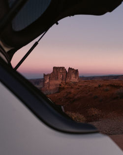 Buildings seen through car window during sunset