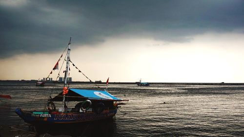 Boat sailing in sea against sky