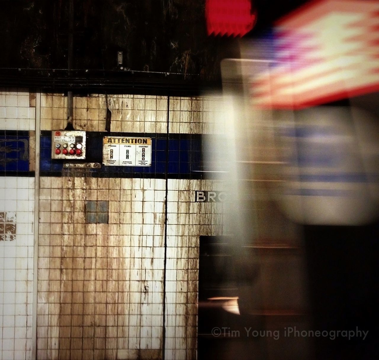 illuminated, text, indoors, western script, architecture, built structure, communication, night, information sign, no people, subway station, transportation, city, guidance, window, modern, capital letter, building exterior, reflection, railroad station