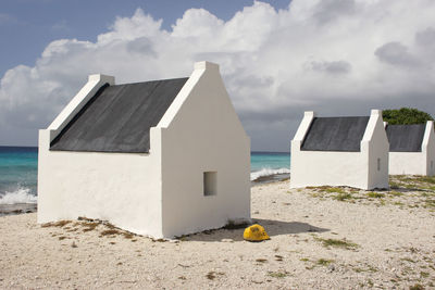 Lifeguard hut on beach against sky