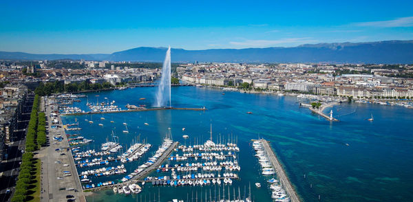 High angle view of city by sea against sky