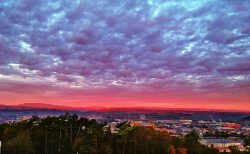 Aerial view of cityscape against dramatic sky