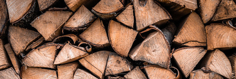 Textured firewood background of chopped wood for kindling and heating the house. a woodpile