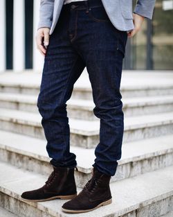 Low section of man standing on staircase