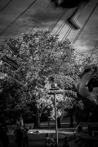 People in amusement park against sky