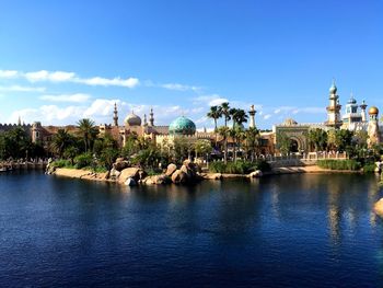 Calm river with buildings in background