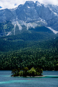 Scenic view of lake and mountains against sky