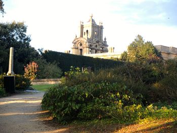 Footpath in front of church against sky