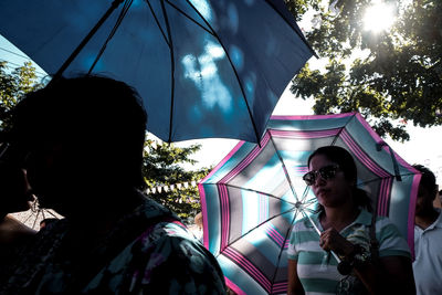 Low angle view of woman standing against sky