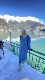 Portrait of woman sitting on snow covered landscape of ritsa lake