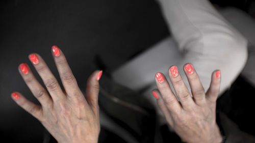 Close-up of cropped hands with nail polish