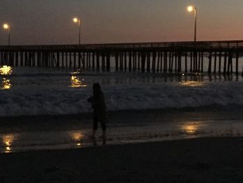 View of illuminated pier at night