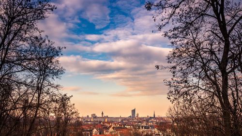 View of cityscape against cloudy sky