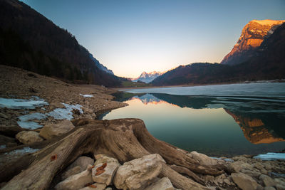 Scenic view of lake and mountains against clear sky