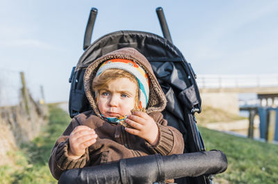 Baby girl sitting in carriage