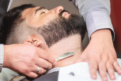 Close-up of man lying on table