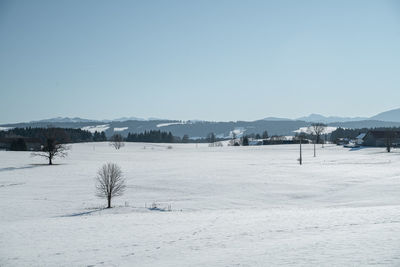 Scenic view of snow covered landscape against clear sky