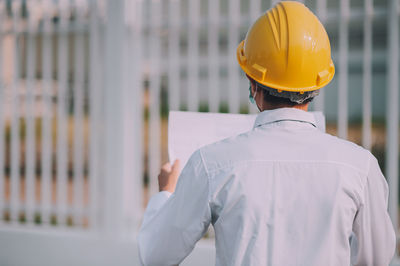 Rear view of man working