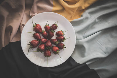 High angle view of red berries on table