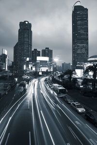 View of city street and buildings against sky