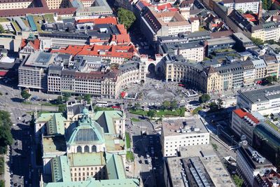 Aerial view of buildings in city during sunny day