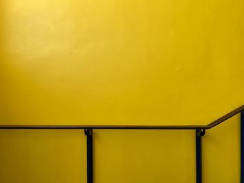 Low angle view of yellow wall