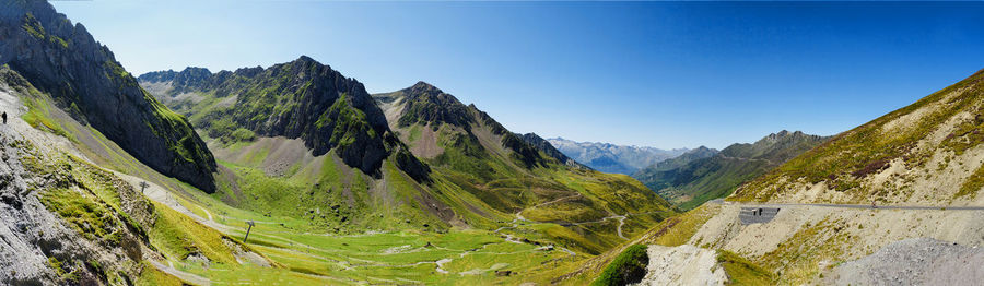 Panoramic view of mountains against clear blue sky