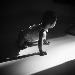 High angle view of child crawling on floor at home