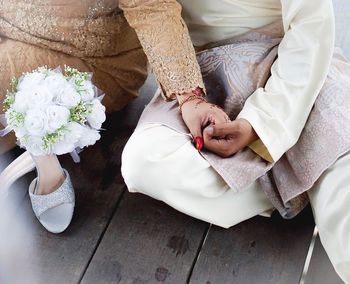 Midsection of woman holding flower bouquet