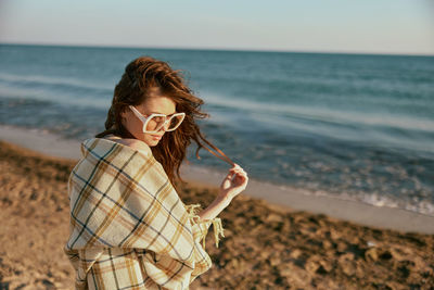 Young woman standing at beach