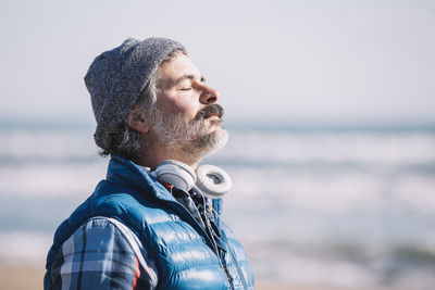 A man on the beach. relaxing deep breathing. winter person