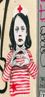 Portrait of man standing against graffiti wall