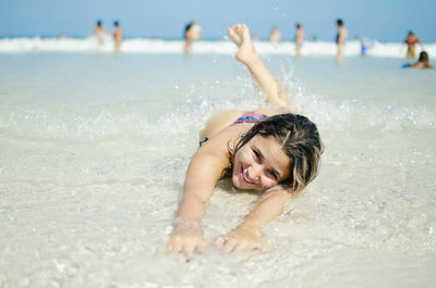 Portrait of happy young woman at beach