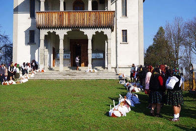 People on field against buildings