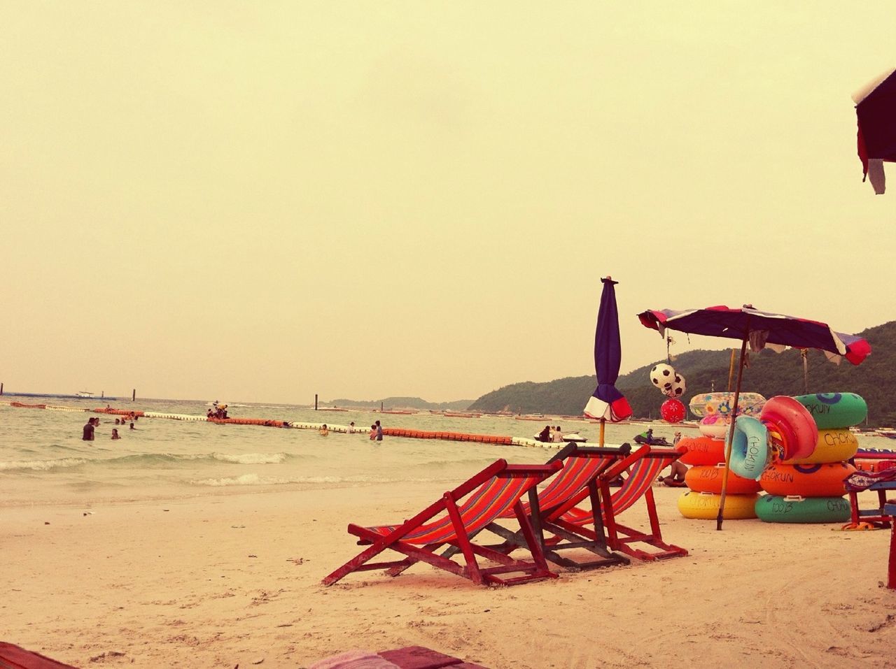 beach, sand, clear sky, copy space, sea, shore, transportation, beach umbrella, outdoors, absence, water, mode of transport, tranquility, incidental people, protection, parasol, vacations, horizon over water, sunlight, day